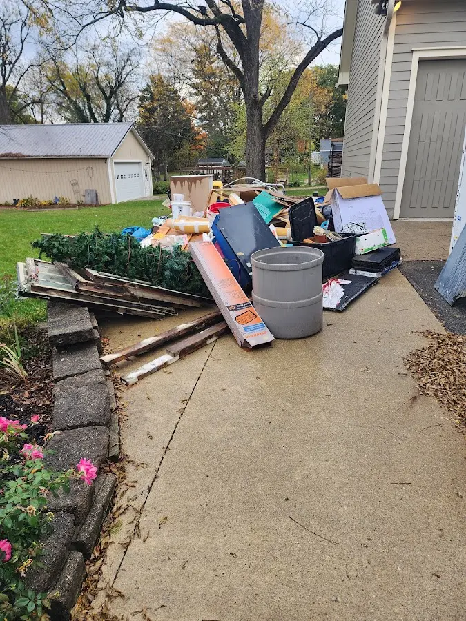 Dumpster being loaded with debris for Estate Cleanout Dumpster Rental in Hollister